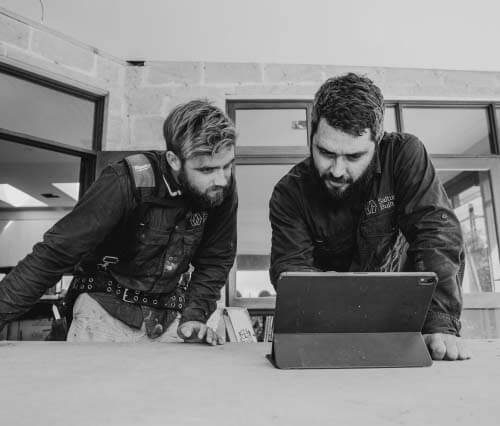 Shaun Ngere and builder looking at plans on a passive house building site